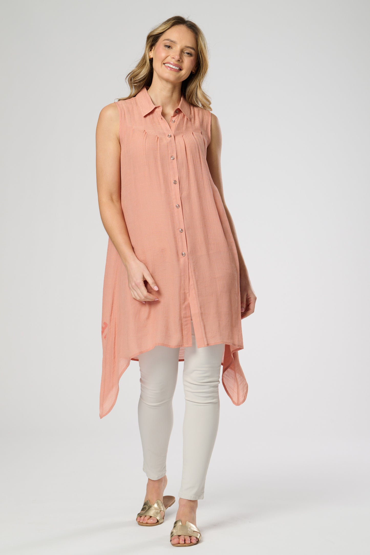 Sleeveless shirt style tunic with side dip hemline