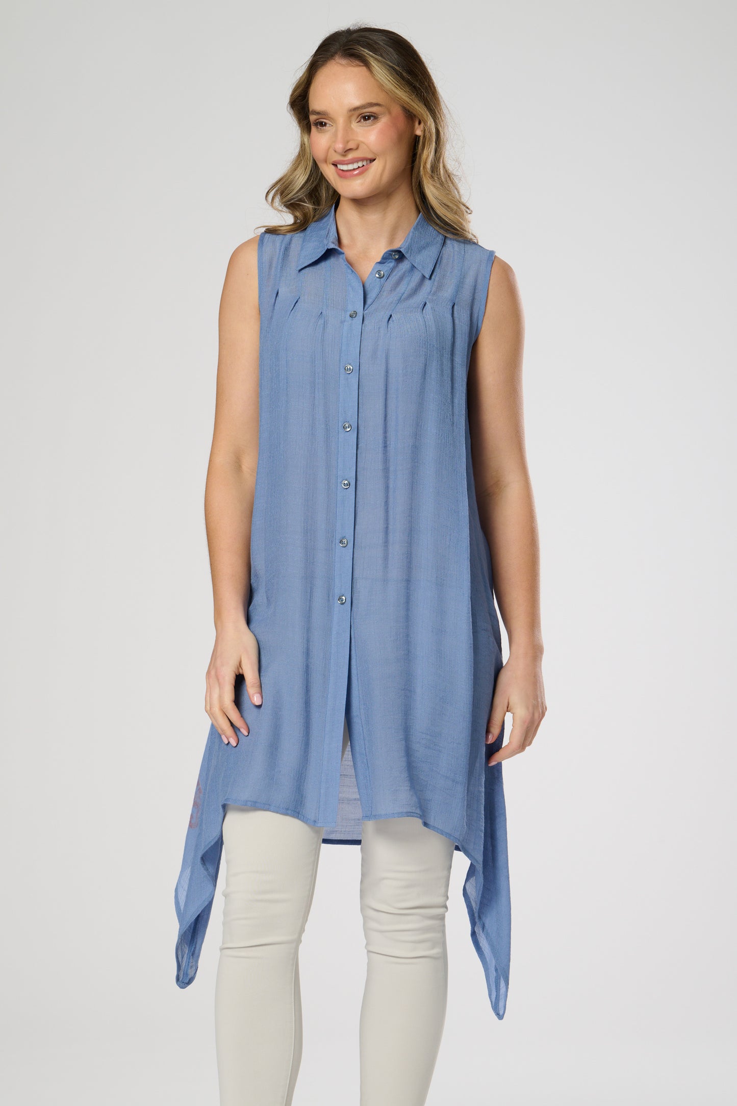 Sleeveless shirt style tunic with side dip hemline