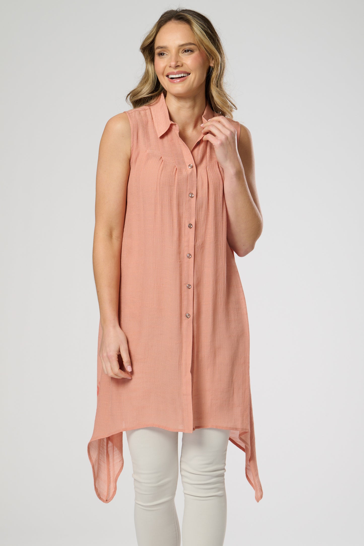 Sleeveless shirt style tunic with side dip hemline